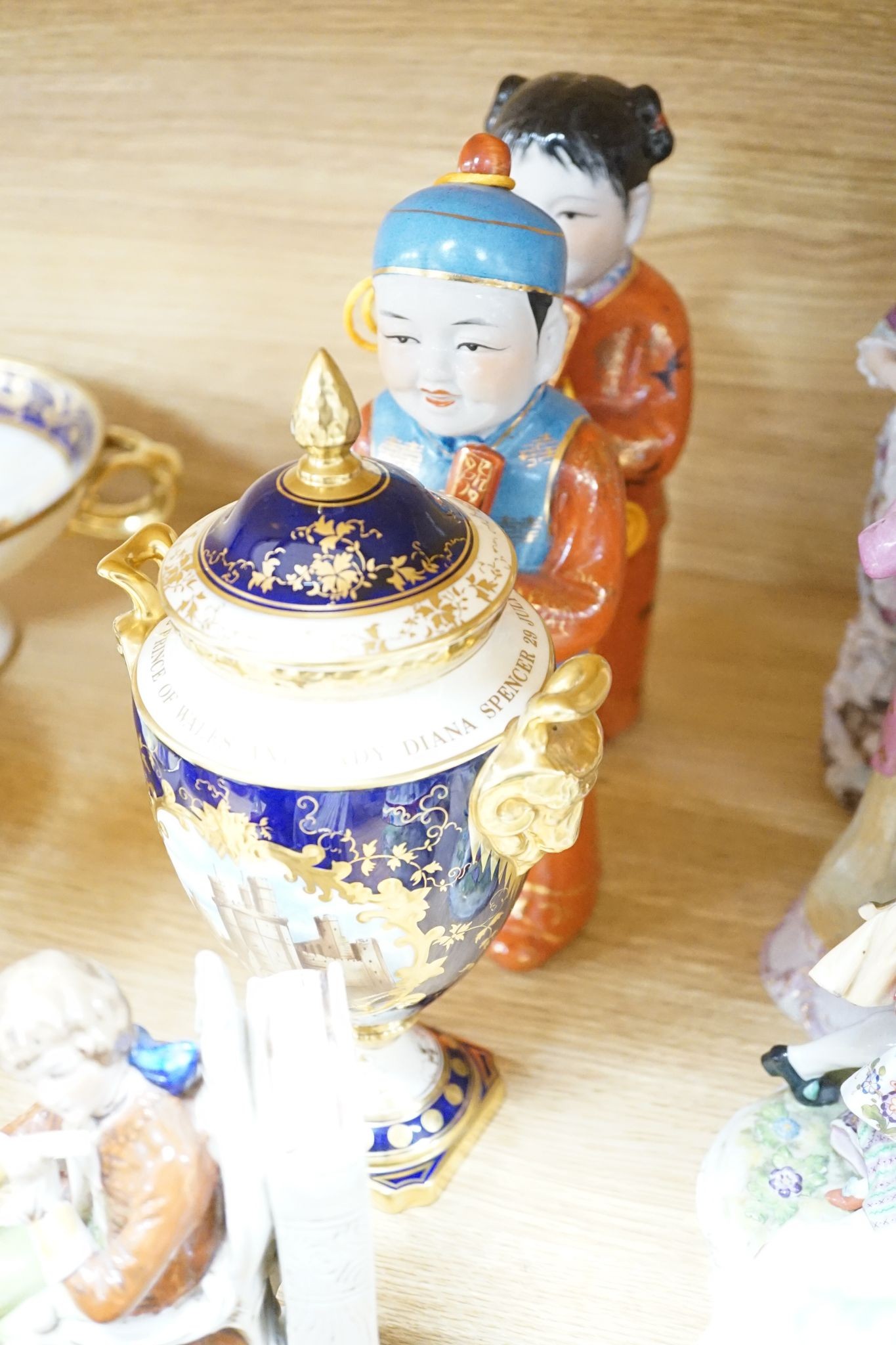 A collection of German and French porcelain figurines, Coalport commemorative urn etc.